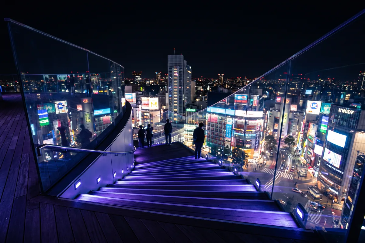 The Shibuya Sky rooftop lit at night above Tokyo