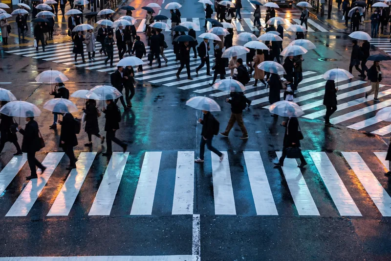 AI-generated — a scramble crossing in the rain