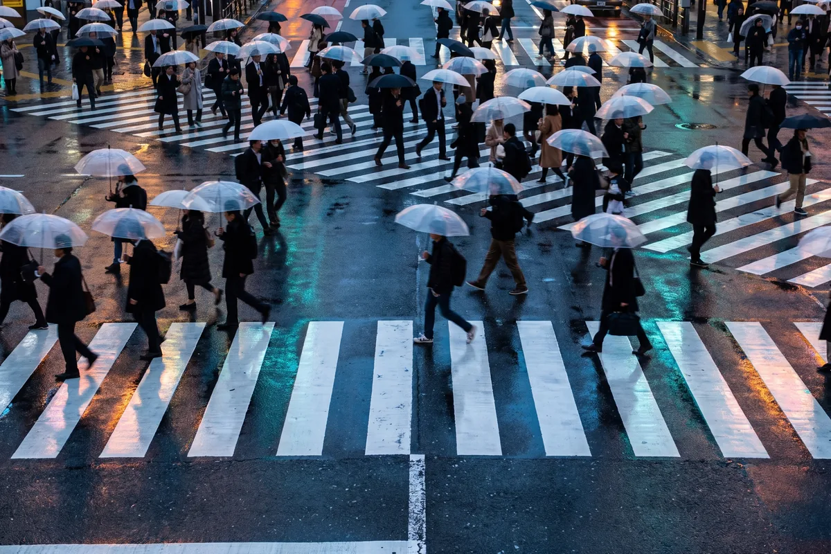 The Shibuya Scramble Crossing filled with people, seen from street level
